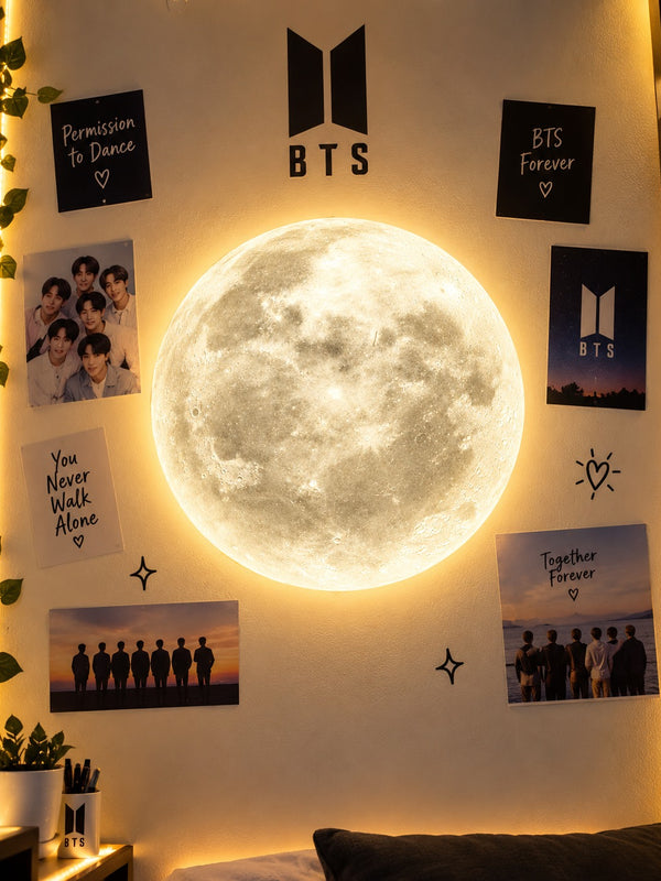 Moon LED wall lamp lit in warm light on a bedroom wall decorated with posters