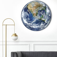 Earth wall light on a white wall above a grey sofa and gold floor lamp