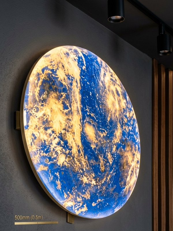 Planet Earth wall light glowing in warm gold tones in a dark room